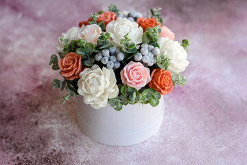 Bouquet of beautiful bright rose flowers in a gift cylindrical cardboard box