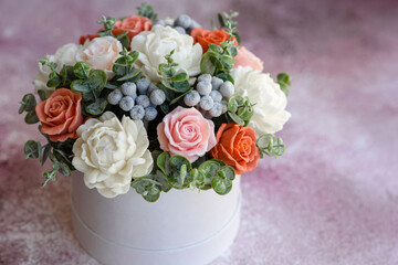 Bouquet of beautiful bright rose flowers in a gift cylindrical cardboard box