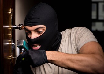 Burglar wearing balaclava mask at crime scene