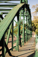 a green iron bridge