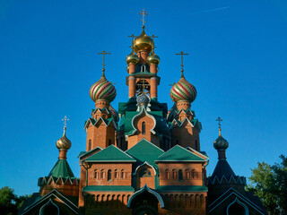 Orthodox church of red brick on a background of blue sky