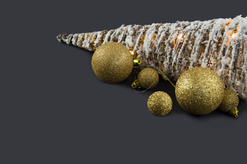 Christmas tree with golden balls toys on a black background