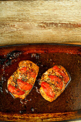 Baked chicken breast in spices stuffed with tomatoes. Copy space.