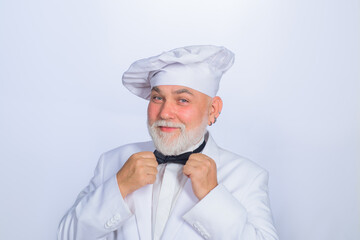 Male chef in white uniform. Cooking. Old bearded cook. Cooking concept. Professional chef man. Happy bearded chef, cook or baker. Smiling chef in uniform.