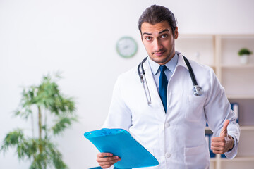 Young male handsome doctor working in the clinic