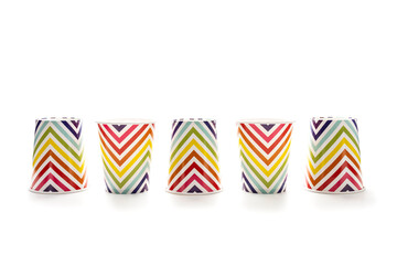 Obraz premium Colorful polka dot paper cups isolated on white.