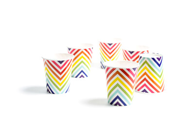 Colorful polka dot paper cups isolated on white.