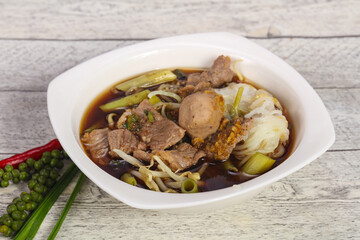 Thai style soup with meat and mushrooms