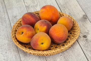 Peach heap in the wooden basket