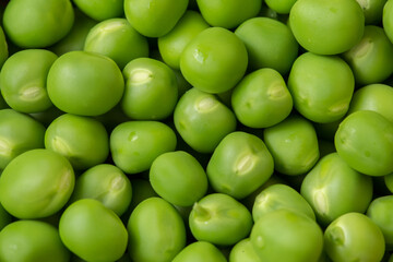 Fresh green peas as background texture close-up.