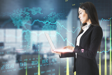 Businesswoman using laptop and global business chart hologram.