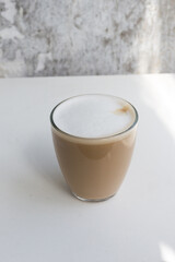 Glass of coffee with cream on a white background