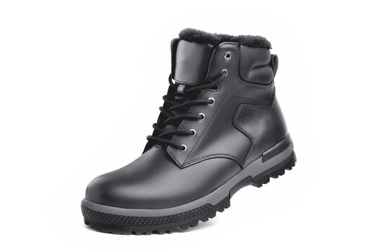 Winter male black leather boot on a white background, hiking shoes, practical off-road shoes, close-up