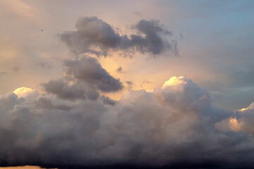 Naklejka na ściany i meble Beautiful sunset sky with clouds. Close-up.