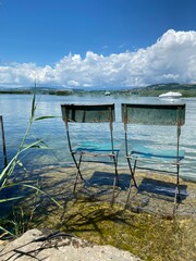 Two vintage chairs at a idyllic lakeside in Morat (Murten) Switzerland