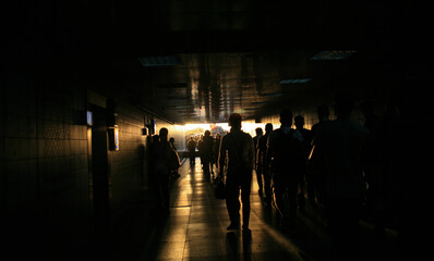 Silhouette of people in the underpass.