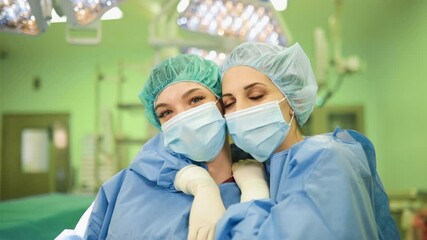Portrait of two happy medical doctors in face masks