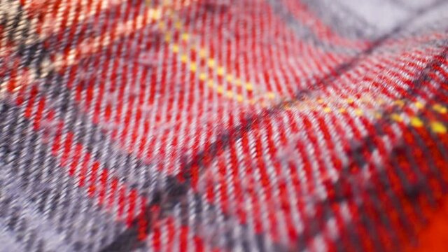 Extreme close up over a plaid patterned flannel shirt.