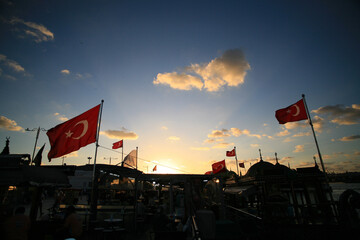 Turkish flag. City silhouette. Sky and clouds