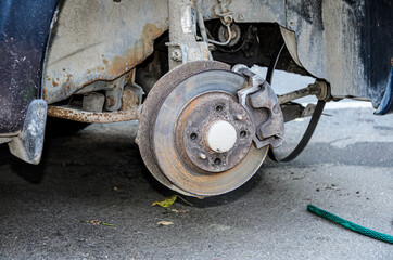 Close up of break disc on car in process of new tire replacement. Car wheel repair, wheel and brake...