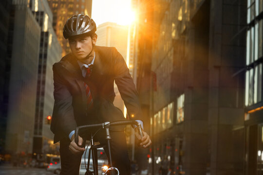 Handsome Brunette Business Man Commuting To Work By Bicycle Wearing Suit And Tie