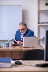 Old male boss employee working in the office