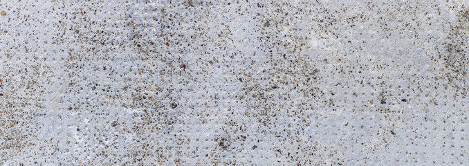 Grey and dirty cement texture marked with a pattern of dots