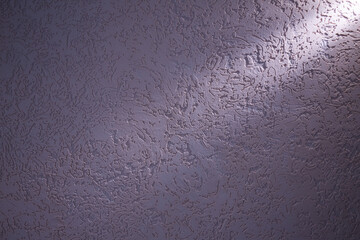 Light violet ray of light diagonally lays on a dark violet structural background