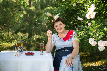 Picture of a middle-aged woman. Concept of emotions. Woman is happy to have rest outdoors after...