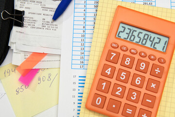 business office desk closeup - financial reports, analysis and accounting, set of documents, tables and graphs, various items for bookkeeping, calculator