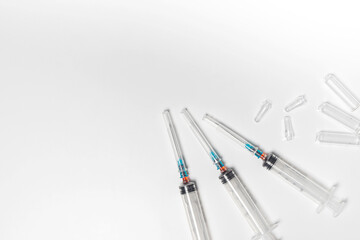 Clean and used hypodermic syringes and ampoules isolated on white background. Treatment background, banner, copy space