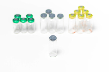 Clean, used and empty medical vials with caps isolated on white background. Top view, samples