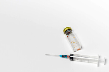 Used medical vial and hypodermic syringe isolated on white background. Hospital treatment banner, top view, copy space