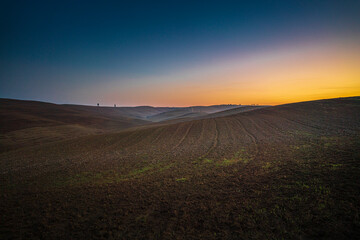 Fototapeta na wymiar Beautiful wide angle view of sunrise over the Tuscany fields and hills