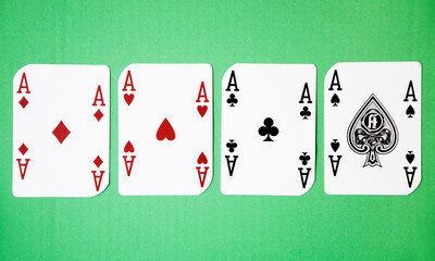Four Aces against green background