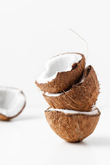 Cracked coconut with pieces on the white background. tropical concept