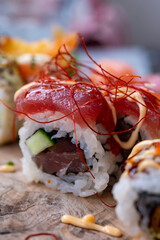 Japanese food, sushi or sashimi made from rice with raw tuna, avocado, cucumber, red fish caviar, tempura shrimps