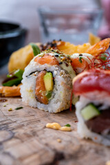 Japanese food, sushi or sashimi made from rice with salmon, avocado, cucumber, red fish caviar, tempura shrimps