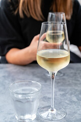 Drinking cold white wine with friends on outdoor terrace, summer vacation