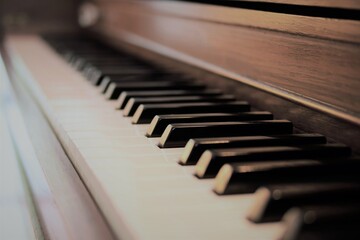 Close up macro view of rustic brown upright piano keyboard. Selective focus with vanishing point. © Carpio Photography