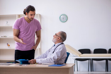 Young male patient visiting old male doctor