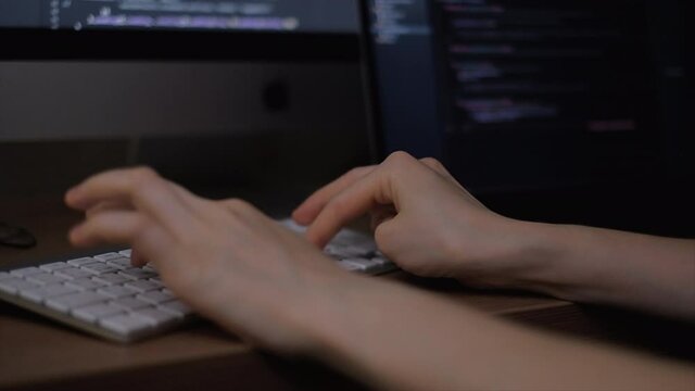 Young female programmer writes program code on a computer. home office	