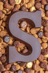 A chocolate letter S on traditional sweets for the celebration of Saint Nicolas or Sinterklaas, a dutch holiday