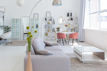 Cozy luxury modern interior design of a studio apartment in extra white colors with fashionable expensive furniture in a minimalist style. white tiled floor, kitchen, relaxation area and workplace