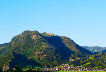 mountain with a village beneath against clear sky