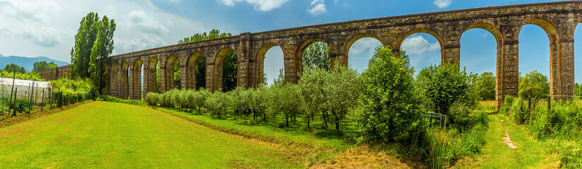 Fototapeta na wymiar A panorama view of the eighteenth century, three-kilometer long Nottolini aqueduct in Lucca Italy in summer