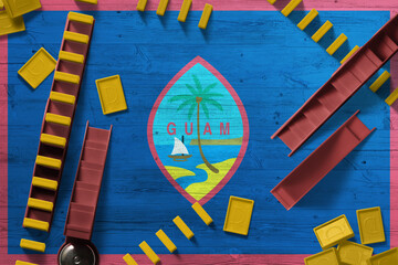 Guam flag with national background with dominoes on wooden table. Top view. Concept of game.