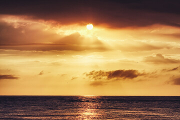 Naklejka na ściany i meble Beautiful Sunset Landscape with Clouds on the Sea.