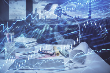 Double exposure of stock market graph drawing and office interior background. Concept of financial analysis.