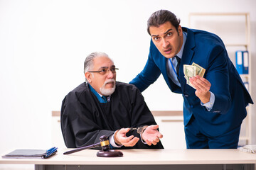 Police inspector arresting old judge in court